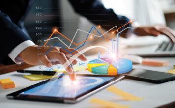 Businessman Using Tablet And Laptop Analyzing Sales Data And Economic Growth Graph Chart. Business Strategy. Digital Marketing. Business Innovation Technology Concept