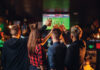 Friends Watches Football On Tv In A Sport Bar