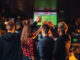 Friends Watches Football On Tv In A Sport Bar