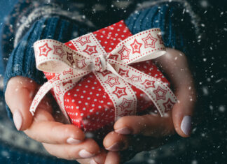 Close Up Shot Of Female Hands Holding A Small Gift