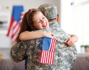 Happy Girl Daughter With American Flag Hugging Father Came Back From Us Army