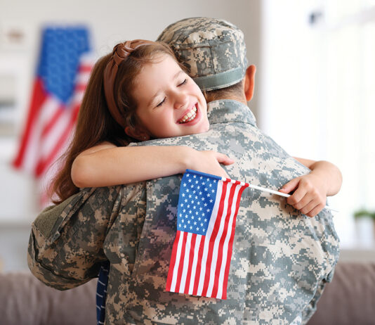 Happy Girl Daughter With American Flag Hugging Father Came Back From Us Army