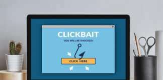 Clickbait Concept On Laptop Screen On Modern Desk