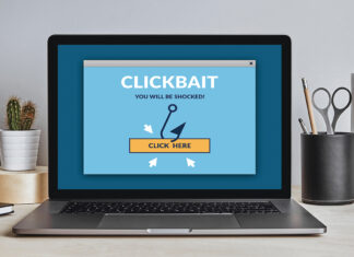 Clickbait Concept On Laptop Screen On Modern Desk