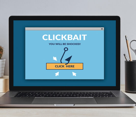 Clickbait Concept On Laptop Screen On Modern Desk