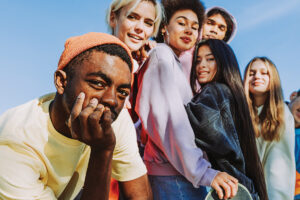 Multiracial Group Of Young Friends Bonding Outdoors