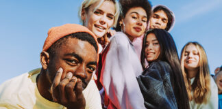 Multiracial Group Of Young Friends Bonding Outdoors