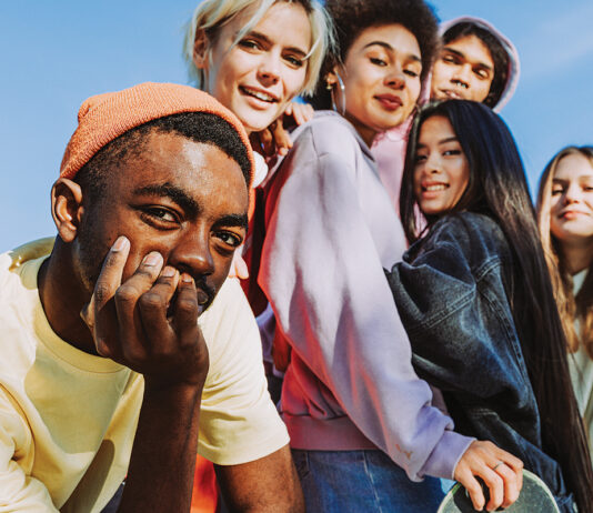 Multiracial Group Of Young Friends Bonding Outdoors