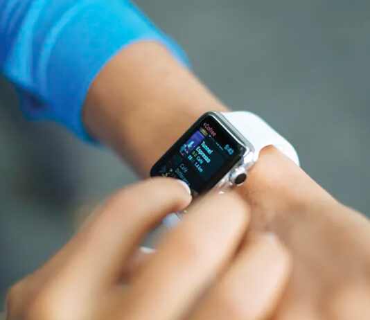 Person Checks Stats On The Screen Of Their Apple Watch. Original