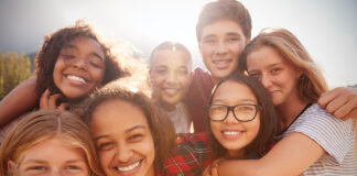 Teenage School Friends Smiling To Camera, Close Up