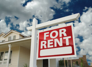 Red And White For Rent Sign In Front Of House