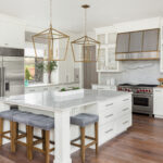 Beautiful Kitchen In New Luxury Home With Island, Pendant Lights, And Hardwood Floors