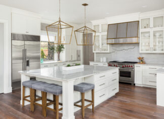 Beautiful Kitchen In New Luxury Home With Island, Pendant Lights, And Hardwood Floors