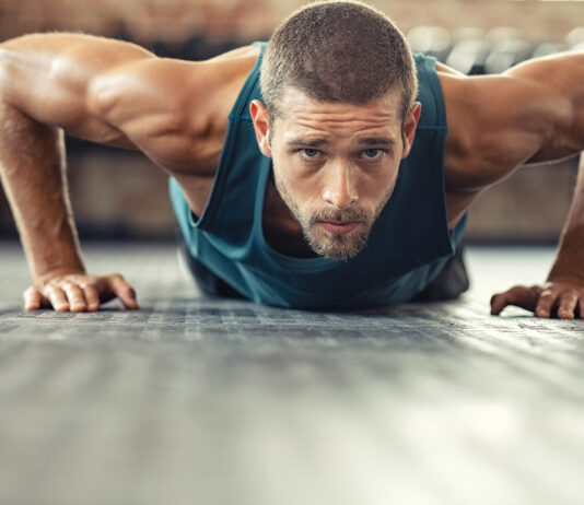 Determined Man Doing Push Ups At The Gym