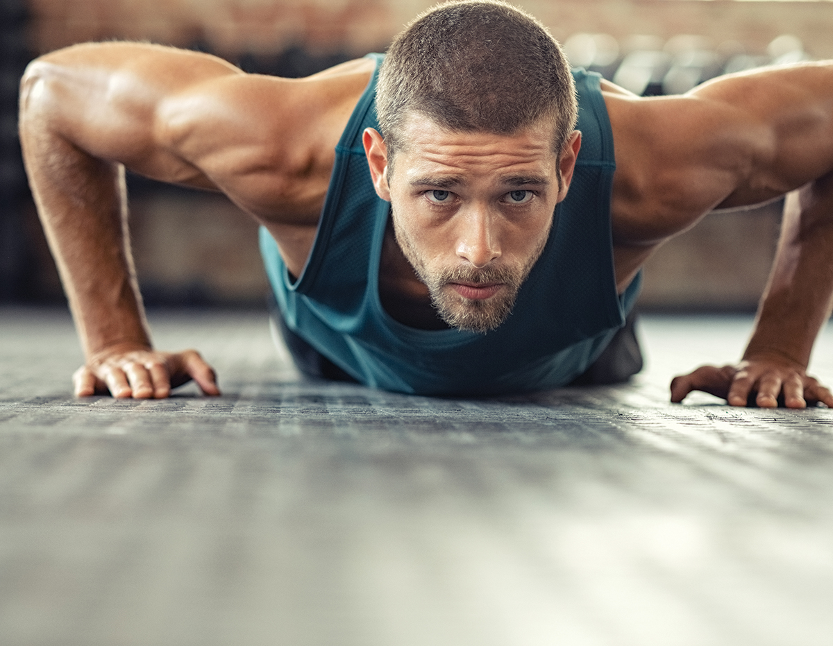 Determined Man Doing Push Ups At The Gym