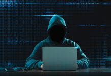 Big Financial Data Theft Concept. An Anonymous Hacker Is Hacking Highly Protected Financial Data Through Computers.