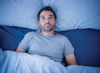 Anxious Man Trying To Sleep But Suffering Insomnia