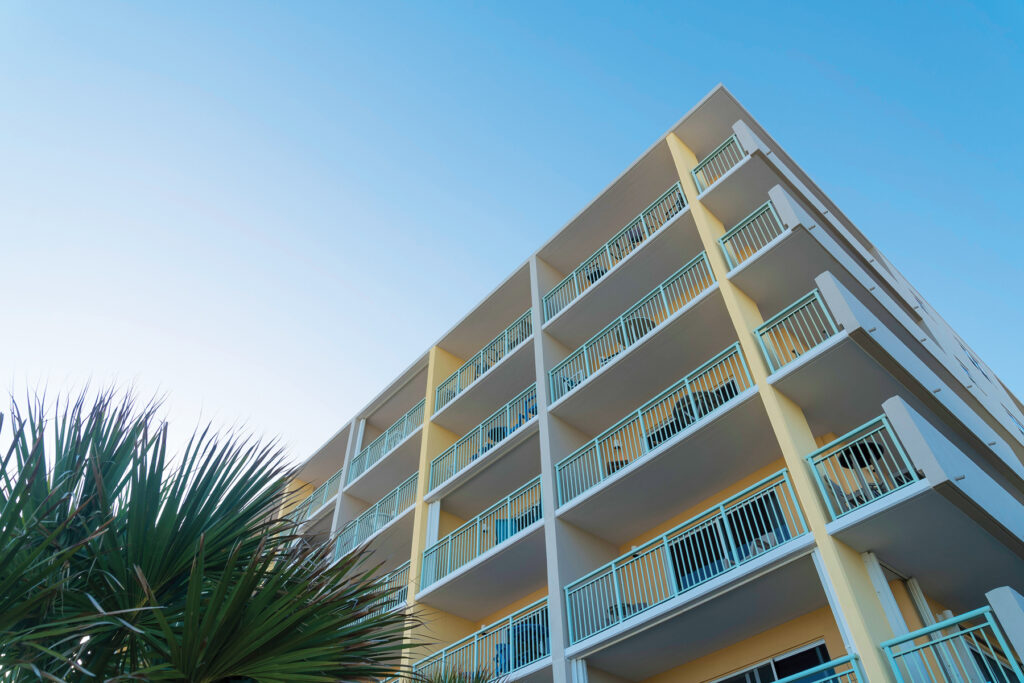 Building Corner With White Balcony Railings In A Low Angle View In Destin, Florida