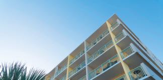 Building Corner With White Balcony Railings In A Low Angle View In Destin, Florida