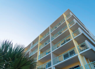 Building Corner With White Balcony Railings In A Low Angle View In Destin, Florida