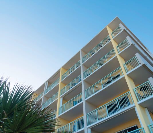 Building Corner With White Balcony Railings In A Low Angle View In Destin, Florida