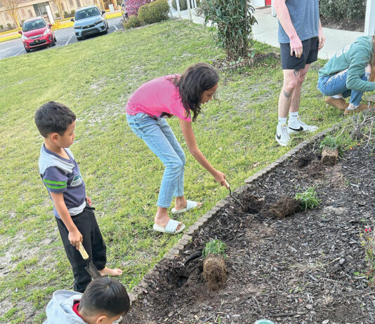 Opportunity Place kids planting flowers