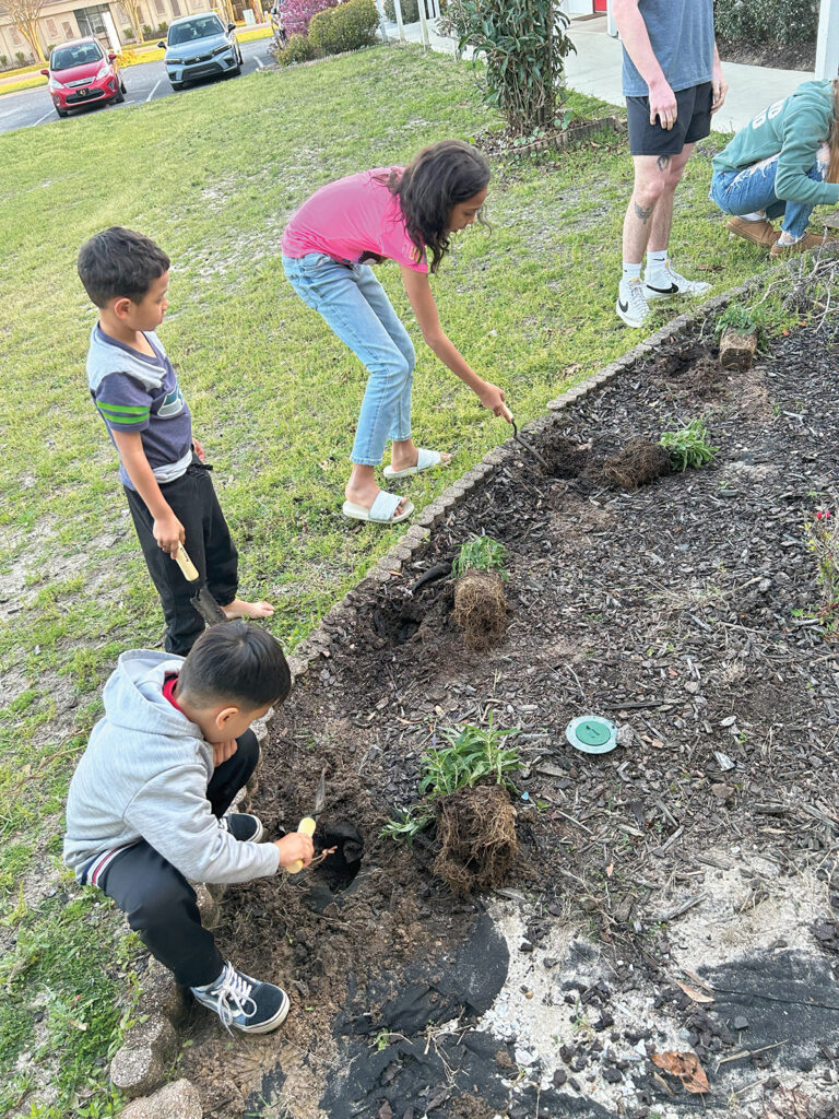 Opportunity Place kids planting flowers